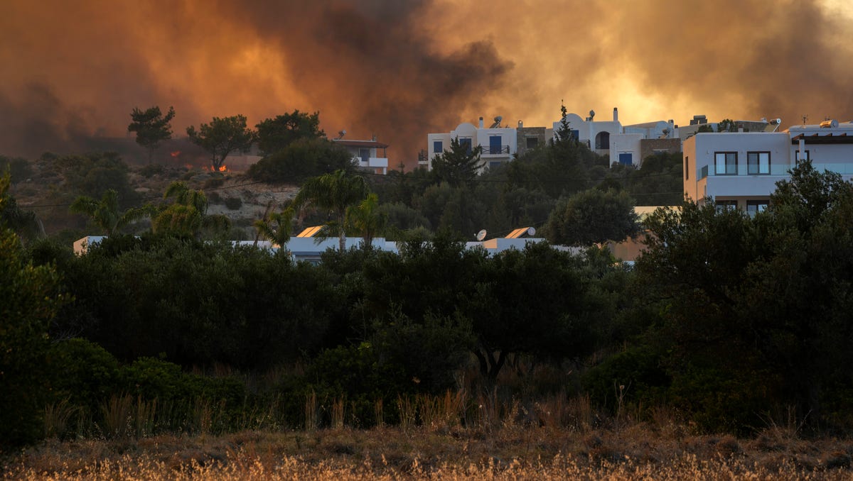 A wildfire burns in Gennadi village, on the Aegean Sea island of Rhodes in southeastern Greece on July 25, 2023.