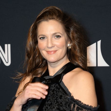 FILE - Drew Barrymore appears at the 24th Annual Mark Twain Prize for American Humor at the Kennedy Center for the Performing Arts on March 19, 2023, in Washington. Barrymore will host the National Book Awards, where Oprah Winfrey will be a guest speaker. (AP Photo/Kevin Wolf, File)