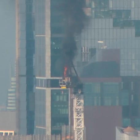 Emergency responders battle flames as a large construction crane caught fire in Manhattan on Wednesday, July 26, 2023 in New York.