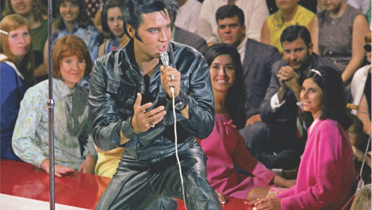 Elvis Presley drops to his knees during a medley of his greatest hits filmed during the 1968 "Singer Special." The black leather suit he is wearing was commissioned after Elvis showed Steve Binder a photo of Marlon Brando in a black leather jacket in the movie "The Wild One."