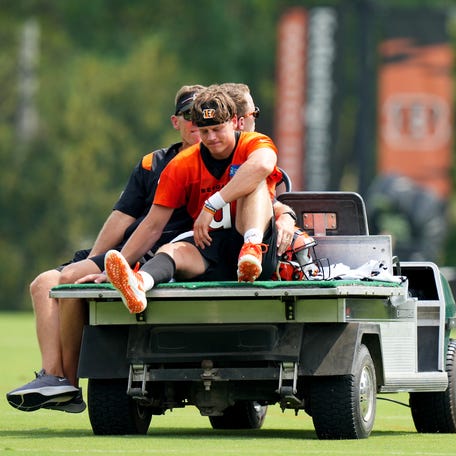 Cincinnati Bengals quarterback Joe Burrow (9) is carted off the field after suffering an injury on a scramble play during Cincinnati Bengals training camp practice, Thursday, July 27, 2023, at the practice fields next to Paycor Stadium in Cincinnati.