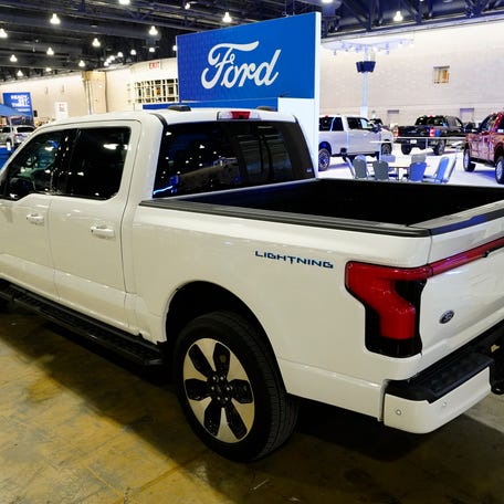 FILE - The Ford F-150 Lightning displayed at the Philadelphia Auto Show, Friday, Jan. 27, 2023, in Philadelphia. Ford is recalling more than 870,000 newer F-150 pickup trucks in the U.S. because the electric parking brakes can turn on unexpectedly. The recall covers certain pickups from the 2021 through 2023 model years with single exhaust systems. Ford's F-Series pickups are the top-selling vehicles in the U.S. (AP Photo/Matt Rourke, File) ORG XMIT: NY150