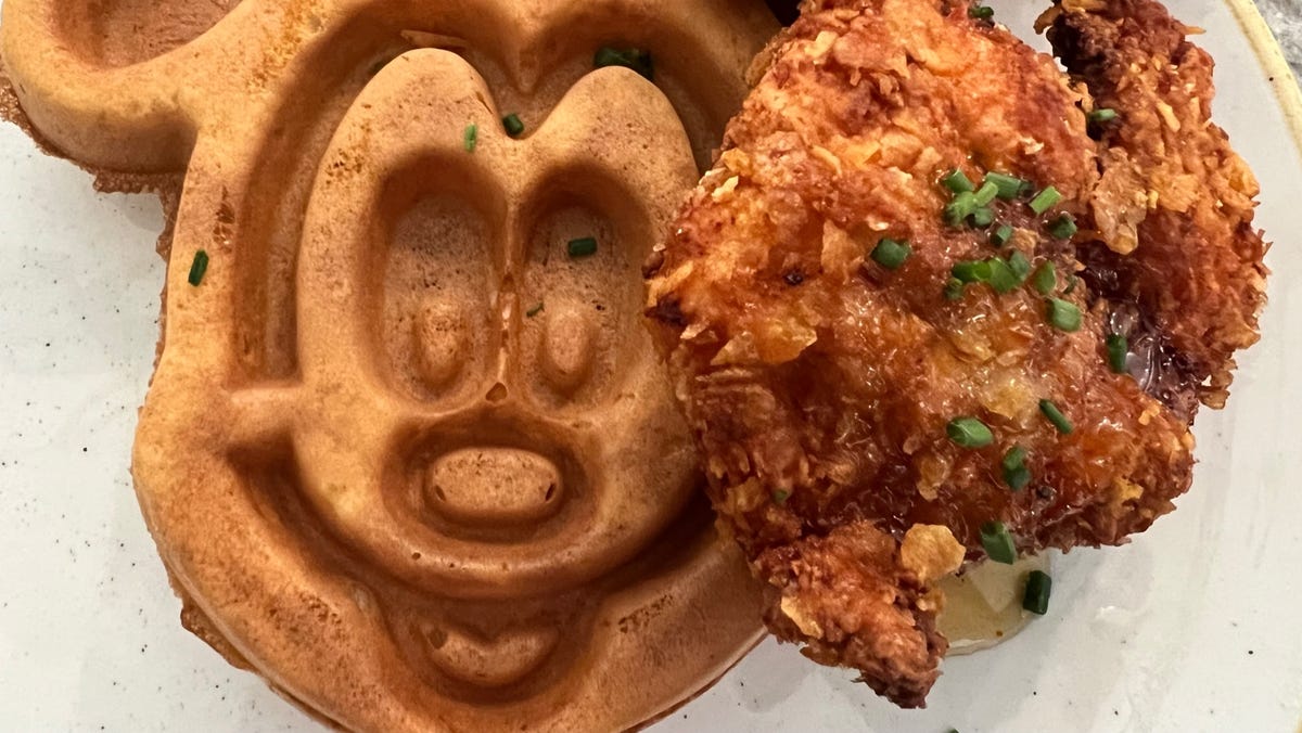 Hand-breaded buttermilk fried chicken is served with a Mickey-shaped malted waffle at Grand Floridian Cafe.