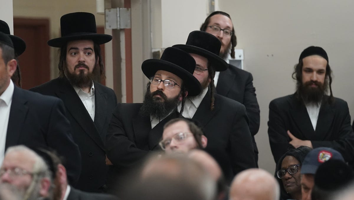 Zev Tarkieltaub, center, listens to remarks during a public hearing on a petition to create a village within the borders of the towns of Thompson and Fallsburg at Viznitz Institutions synagogue in Kiamesha Lake on Thursday, August 3, 2023.