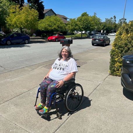 Deanna Vaillancourt-Thompson at home in her wheelchair.
