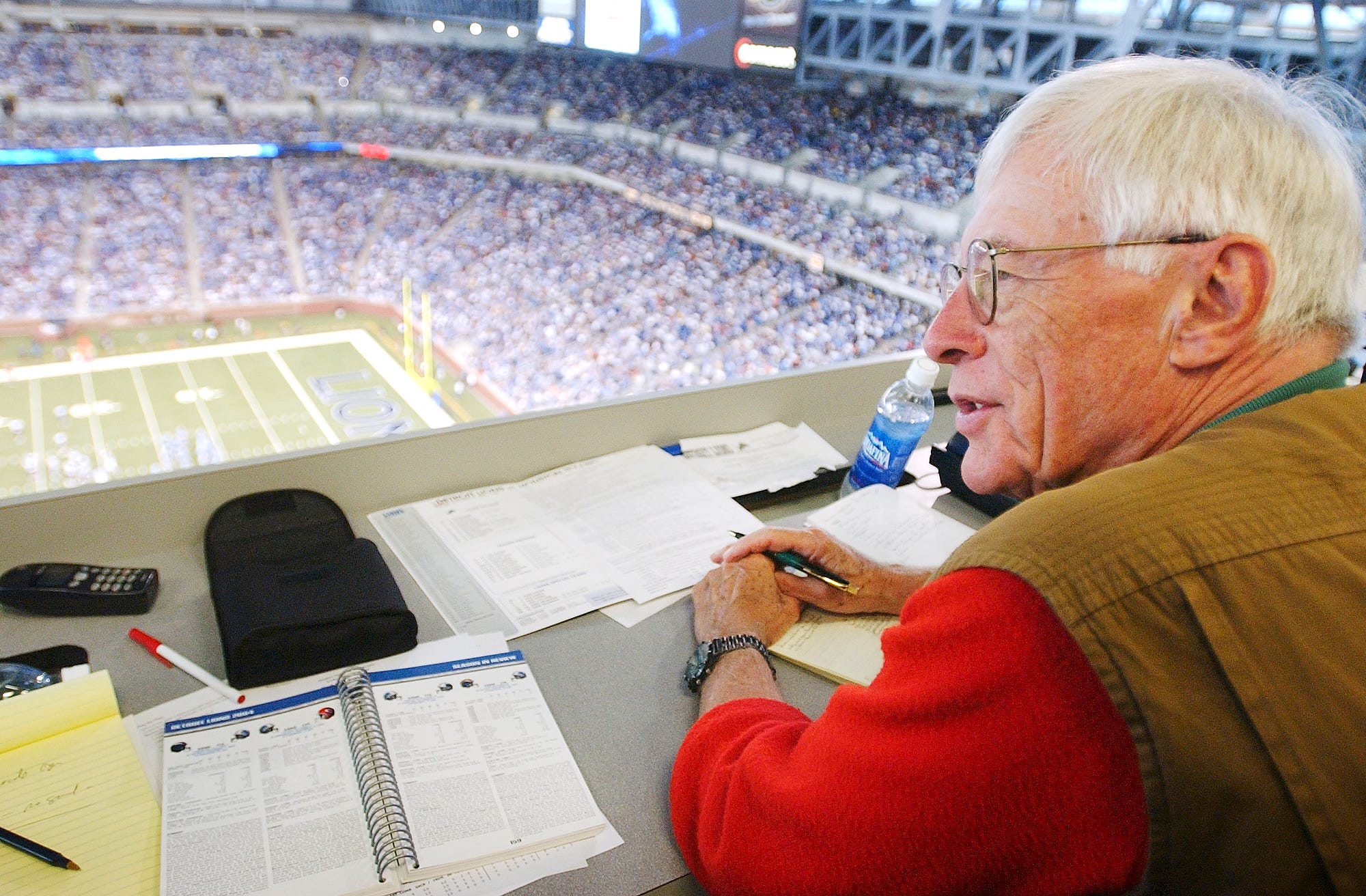 Retiring Detroit News sports writer Jerry Green watches 4th quarter action of the Detroit Lions 28-16 win over the Houston Texans from his seat in the press box at Ford Field in Detroit, Michigan on September 19, 2004.