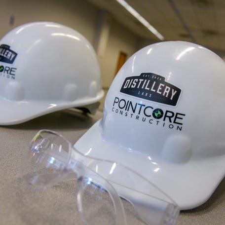 Hard hats from PointCore Construction display a Distillery Labs sticker during a ceremony Thursday, Aug. 17, 2023 kicking off renovations to the building at 201 SW Adams Street that will become the headquarters of the new Distillery Labs innovation center in downtown Peoria.