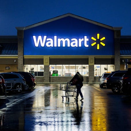 A shopper pushes a cart through the parking lot of a Walmart on the morning of Black Friday in Wilmington, Delaware, on November 25, 2022. Walmart raised its full-year forecast on August 17, 2023, following a jump in quarterly profits, pointing to solid increases at US stores and e-commerce. The big retailer, which has been seen as well positioned amid inflation because of its reputation for value, enjoyed another quarter of growing sales.