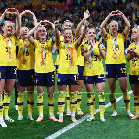 Sweden players celebrate after beating Australia 2-0 in the third-place game.