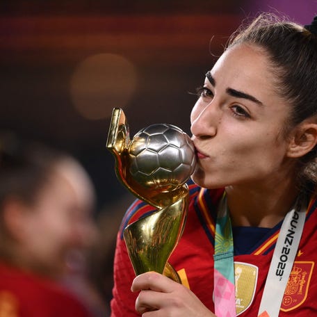 Spain's defender #19 Olga Carmona kisses the trophy after winning the Australia and New Zealand 2023 Women's World Cup final football match between Spain and England at Stadium Australia in Sydney on August 20, 2023. (Photo by FRANCK FIFE / AFP) (Photo by FRANCK FIFE/AFP via Getty Images) ORIG FILE ID: AFP_33RV7GL.jpg