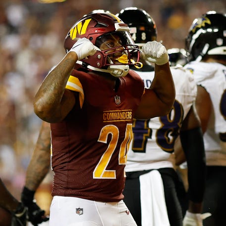 Washington Commanders running back Antonio Gibson celebrates after scoring a touchdown against the Baltimore Ravens.