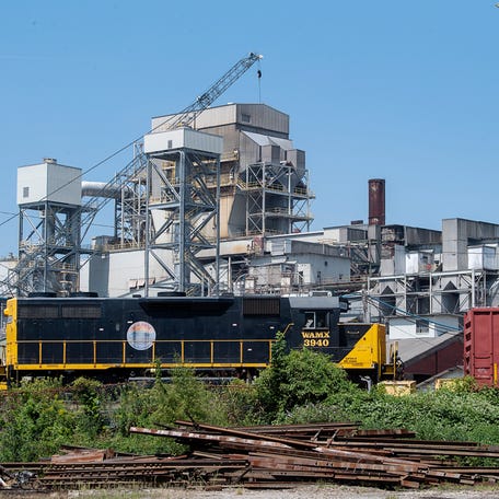 The Canton mill's smokestacks are being disassembled with the help of a crane on Aug. 23, 2023.