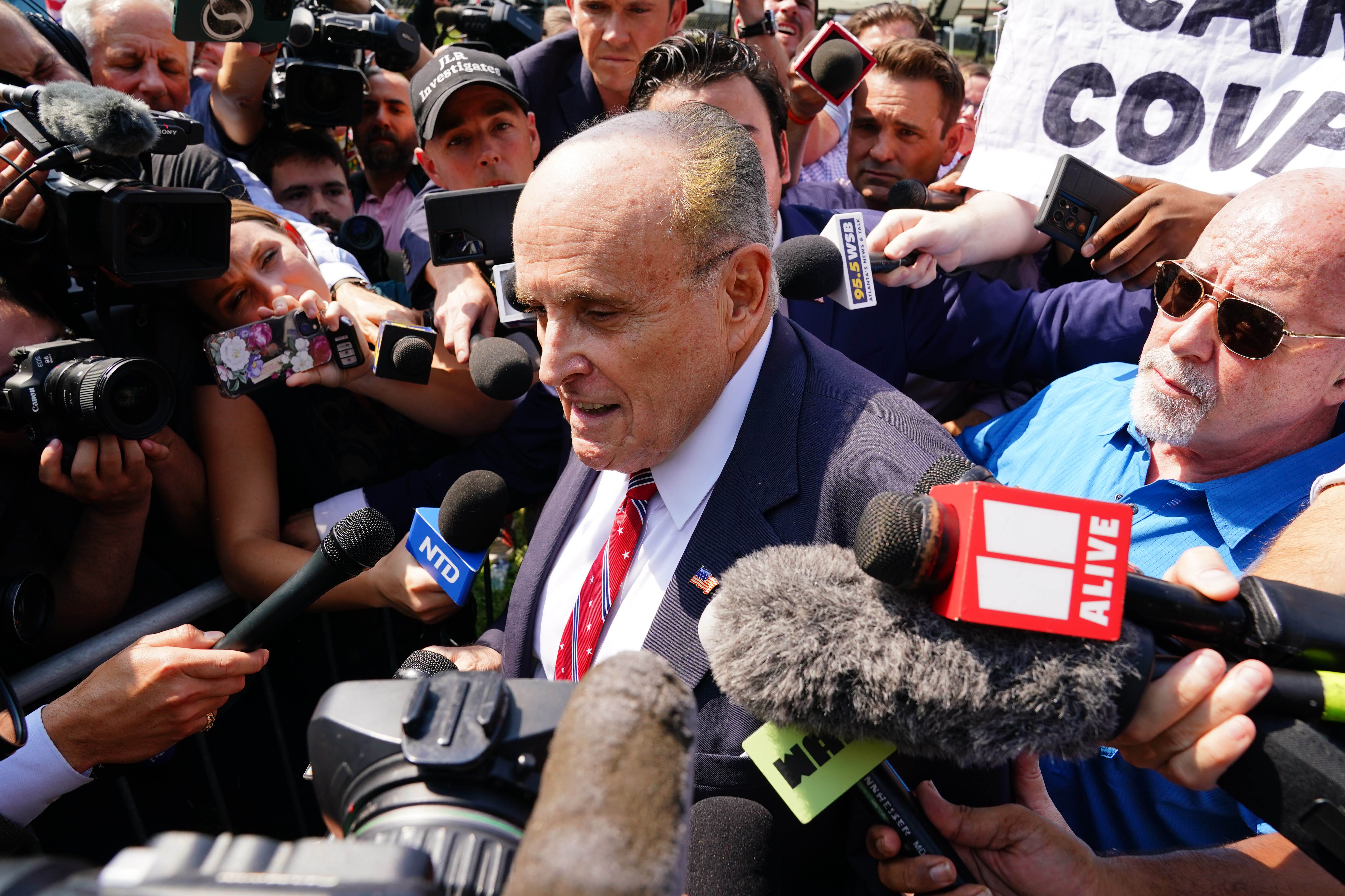 Aug 23, 2023; Atlanta, GA, USA; Former Trump attorney Rudy Giuliani speaks with the media after being processed at the Fulton County Jail. A grand jury in Fulton County, Georgia indicted Donald Trump. The indictment includes 41 charges against 19 defendants, from the former president to his former attorney Rudy Guiliani and former White House Chief of Staff Mark Meadows. The legal case centers on the state's RICO statute, the   Racketeer Influenced and Corrupt Organizations Act.