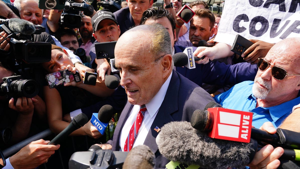 Aug 23, 2023; Atlanta, GA, USA; Former Trump attorney Rudy Giuliani speaks with the media after being processed at the Fulton County Jail. A grand jury in Fulton County, Georgia indicted Donald Trump. The indictment includes 41 charges against 19 defendants, from the former president to his former attorney Rudy Guiliani and former White House Chief of Staff Mark Meadows. The legal case centers on the state's RICO statute, the   Racketeer Influenced and Corrupt Organizations Act.