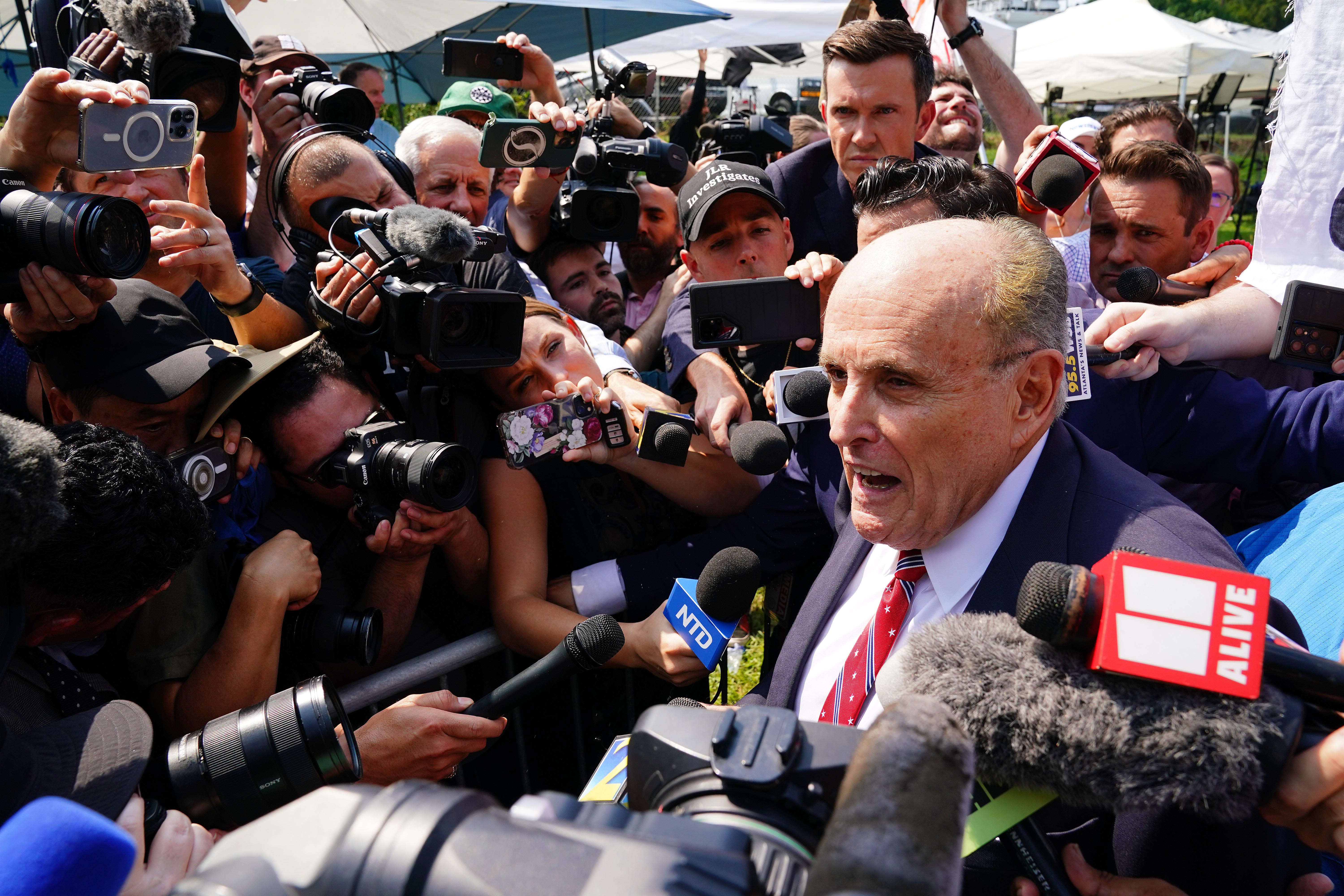 Aug 23, 2023; Atlanta, GA, USA; Former Trump attorney Rudy Giuliani speaks with the media after being processed at the Fulton County Jail. A grand jury in Fulton County, Georgia indicted Donald Trump. The indictment includes 41 charges against 19 defendants, from the former president to his former attorney Rudy Guiliani and former White House Chief of Staff Mark Meadows. The legal case centers on the state's RICO statute, the   Racketeer Influenced and Corrupt Organizations Act.