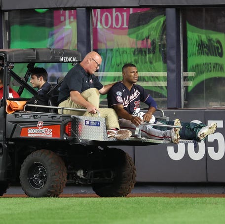 Washington Nationals left fielder Stone Garrett is driven off the field after suffering a leg injury in the seventh inning at Yankee Stadium.