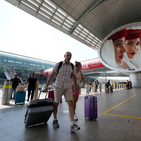 Passengers arrive at Dubai International Airport on Oct. 25, 2022.