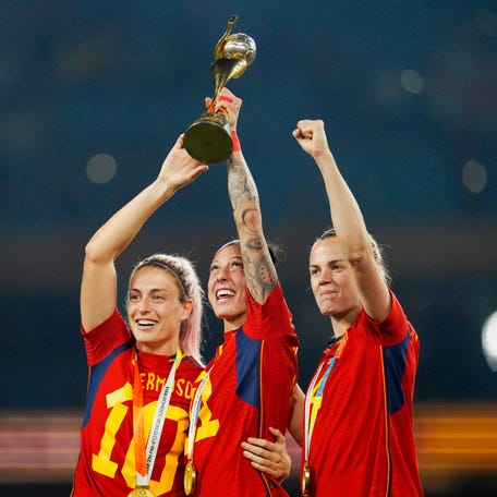 Spain's Alexia Putellas, Jennifer Hermoso and Irene Paredes ,from left, celebrate with the trophy at the end of the Women's World Cup soccer final between Spain and England at Stadium Australia in Sydney, Australia, Sunday, Aug. 20, 2023. Spain won 1-0. (AP Photo/Abbie Parr) ORG XMIT: MNAP118