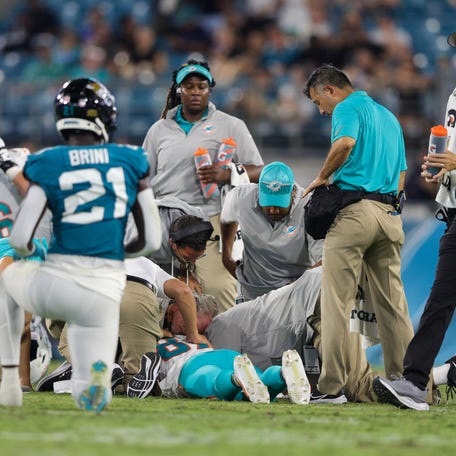 Dolphins wide receiver Daewood Davis is attended to by medical staff during the fourth quarter of the preseason game against the Jaguars.