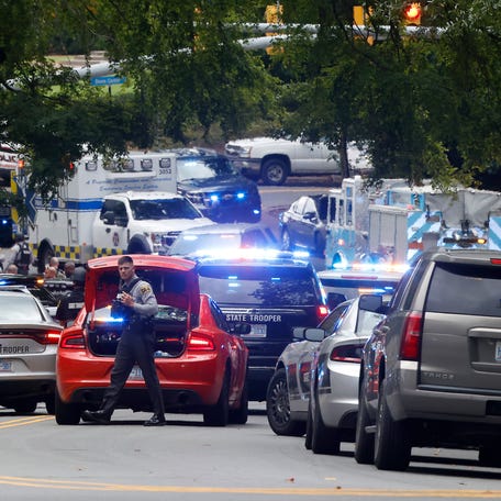 Law enforcement and first responders gather on South Street near the Bell Tower on the University of North Carolina at Chapel Hill campus in Chapel Hill, N.C., Monday, Aug. 28, 2023, after a report of an "armed and dangerous person" on campus.