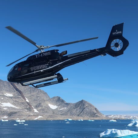 A helicopter from the Scenic Eclipse II in the skies over the Skjoldungen Fjord in eastern Greenland.