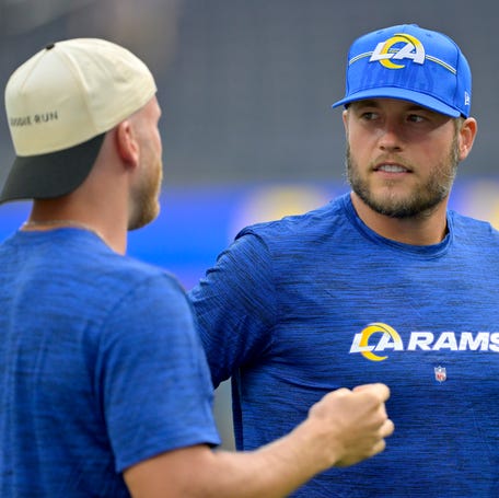 Matthew Stafford talks with Rams wide receiver Cooper Kupp on the field prior to a preseason game.
