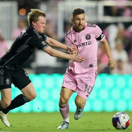 Inter Miami's Lionel Messi attempts to dribble the ball around Nashville SC's Dax McCarty.