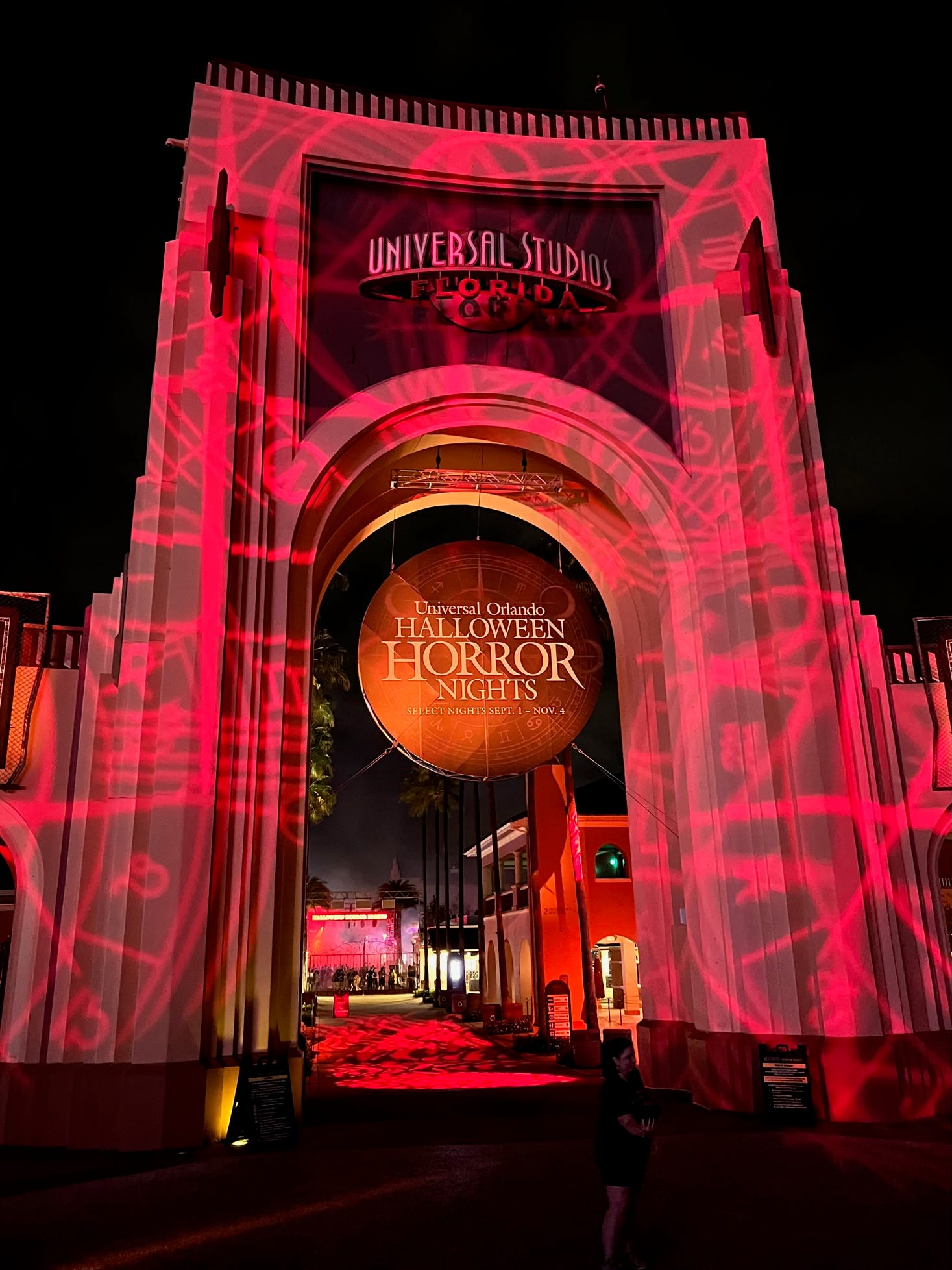 The Halloween Horror Nights sign is cast in an eerie red light at the end of HHN's opening night at Universal Orlando.
