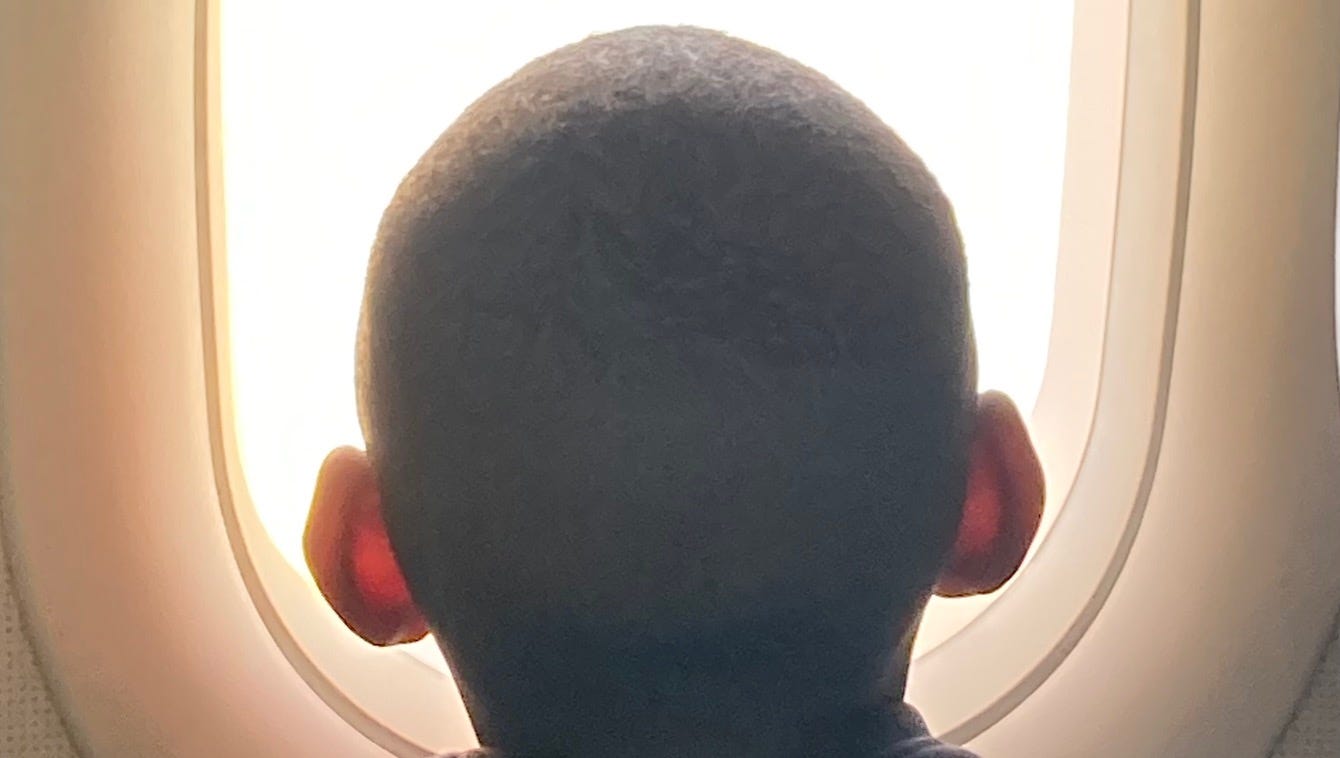 A young traveler stares out the window of a Frontier flight to Orlando, one of the most visited cities in the U.S.