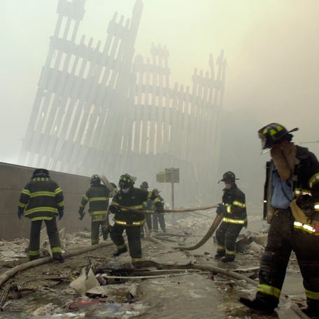Firefighters work beneath the destroyed mullions, the vertical struts which once faced the soaring outer walls of the World Trade Center towers, after a terrorist attack in New York, Sept. 11, 2001. The remains of two people who died in the 9/11 attack on the World Trade Center have been identified, the latest positive identification in the decades-long effort to return victims to their families. Authorities confirmed the identification of the remains of   a man and woman days ahead of the 22nd anniversary of the hijacked-plane attack that killed nearly 3,000 people in Lower Manhattan.