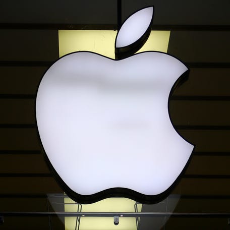 FILE - The Apple logo is illuminated at a store in the city center in Munich, Germany, on Dec. 16, 2020. (AP Photo/Matthias Schrader, File) ORG XMIT: NYBZ505