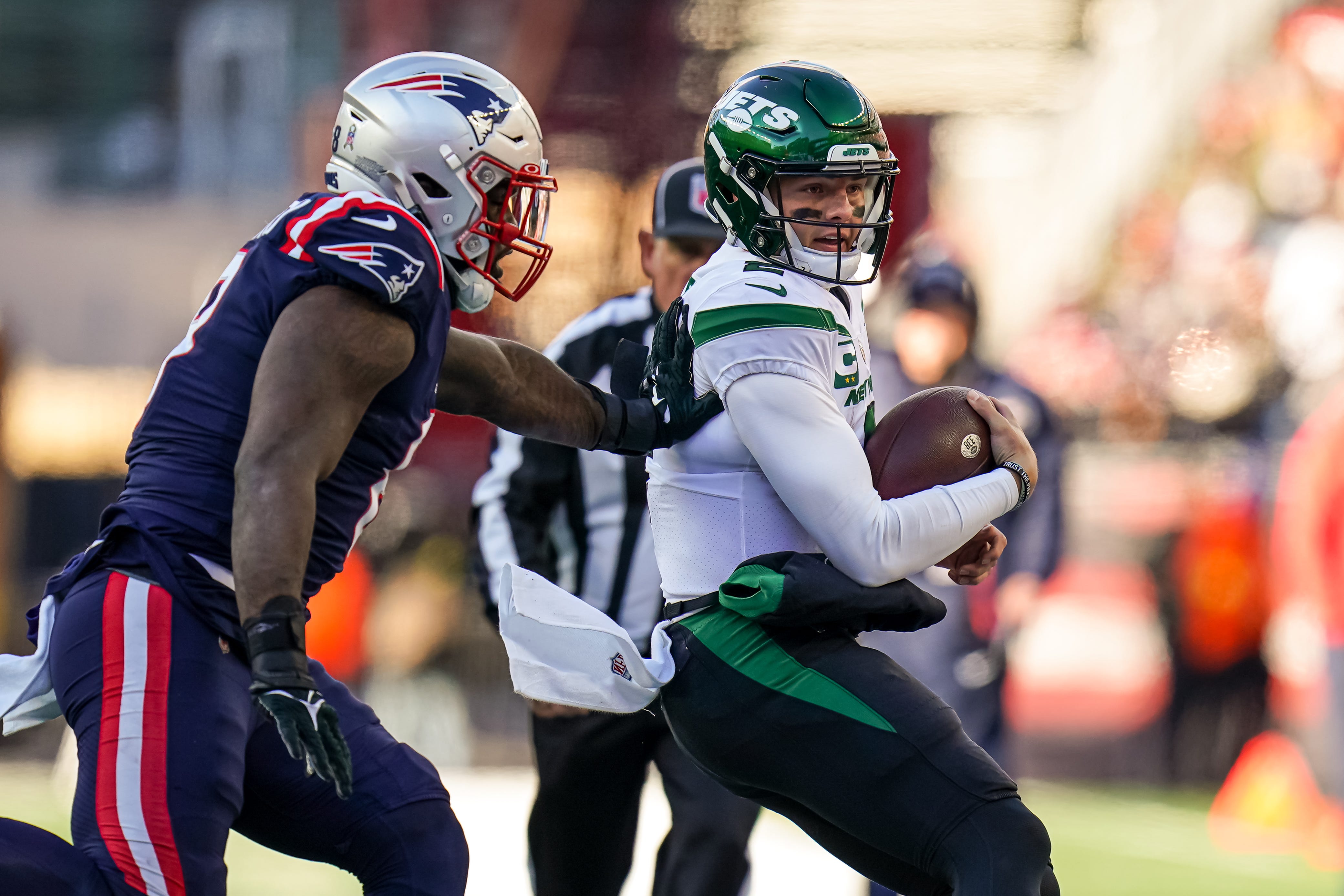 New York Jets quarterback Zach Wilson (2) runs the ball against the New England Patriots in the first half at Gillette Stadium.