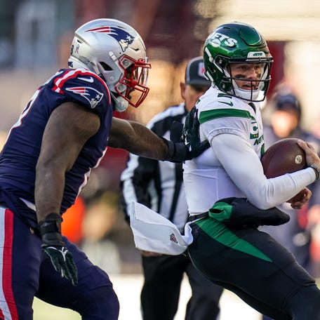 New York Jets quarterback Zach Wilson (2) runs the ball against the New England Patriots in the first half at Gillette Stadium.