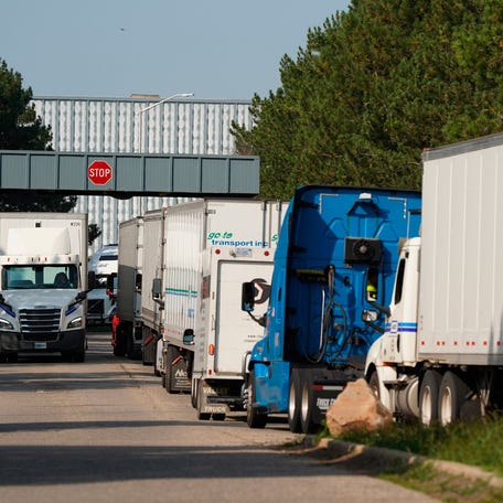 Trucks line up to enter the General Motors Corporation CCA Parts Division in Swartz Creek on Friday, September 22, 2023 ahead of strikes.