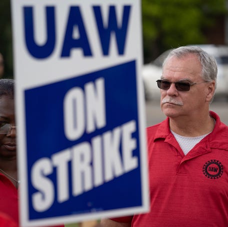 UAW Secretary-Treasurer Margaret Mock, left and UAW Vice President Mike Booth talk with General Motors Corporation Davison Road Processing Center employees outside of the plant in Burton on Friday, September 22, 2023.