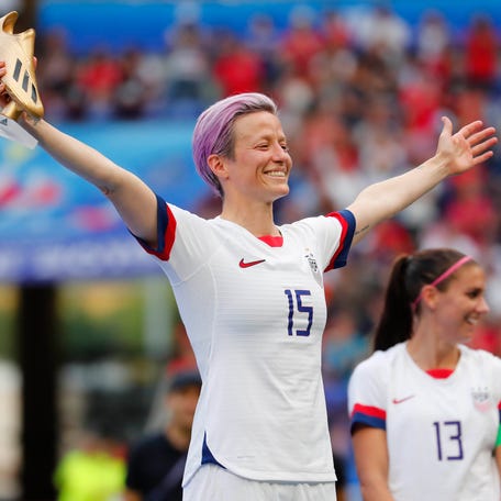 Megan Rapinoe celebrates with the Golden Boot after the USWNT won the 2019 World Cup.