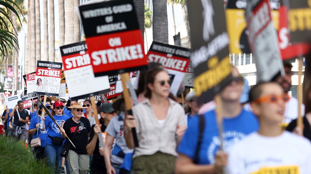 Striking WGA (Writers Guild of America) members picket with striking SAG-AFTRA members outside Netflix studios on September 22, 2023 in Los Angeles, California.