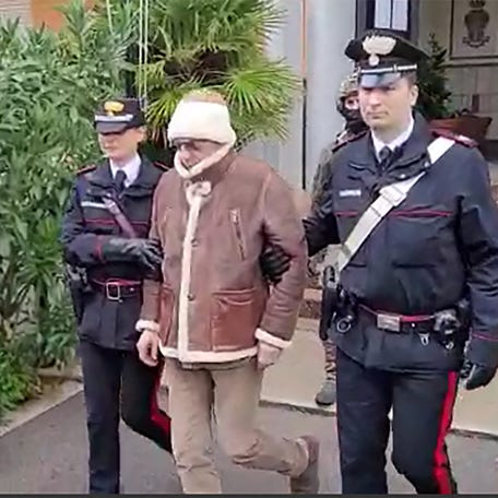(FILES) This handout video grab taken and released by the Italian Carabinieri Press Office on January 16, 2023 shows the transfer of Italy's top wanted mafia boss, Matteo Messina Denaro (C) from the Carabinieri police station of San Lorenzo in Palermo, to an undisclosed location, following his arrest in his native Sicily on January 16, 2023 after 30 years on the run. Notorious Sicilian Mafia boss Matteo Messina Denaro, captured in January after three decades on   the run, has died in hospital in central Italy, the ANSA news agency reported September 25, 2023. (Photo by Handout / ITALIAN CARABINIERI PRESS OFFICE / AFP) / RESTRICTED TO EDITORIAL USE - MANDATORY CREDIT "AFP PHOTO / HANDOUT / ITALIAN CARABINIERI PRESS OFFICE " - NO MARKETING NO ADVERTISING CAMPAIGNS - DISTRIBUTED AS A SERVICE TO CLIENTS (Photo by HANDOUT/ITALIAN CARABINIERI PRESS OFFICE/AFP via Getty Images) ORIG FILE ID: AFP_33WG8G6.jpg