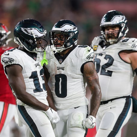 Philadelphia Eagles running back D'Andre Swift (0) and wide receiver Olamide Zaccheaus (13) react after a run against the Tampa Bay Buccaneers.