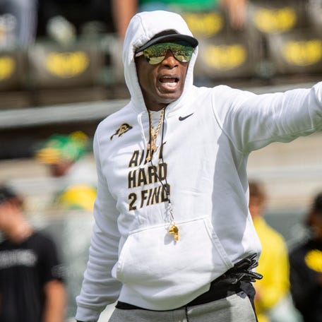 Deion Sanders walks the field during warmups before Colorado's game against Oregon.