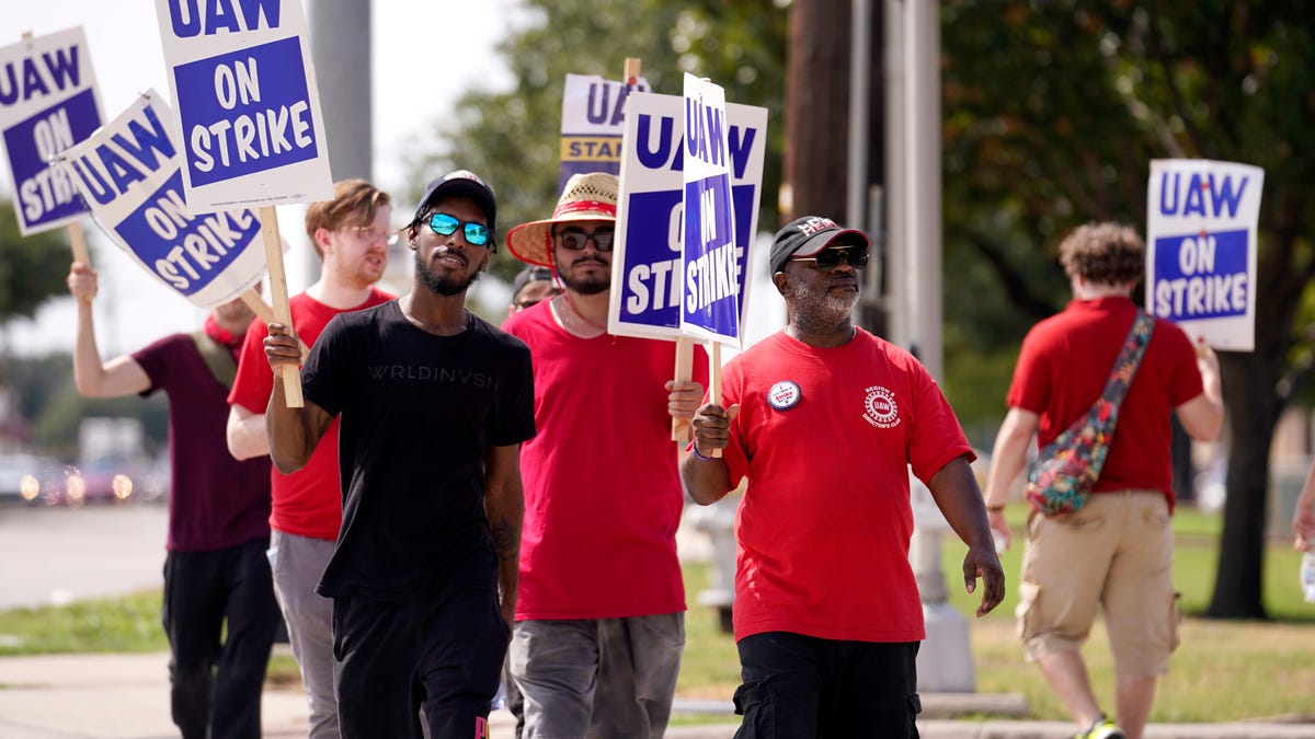 UAW union members picket on the street in front of a Stellantis distribution center, Monday, Sept. 25, 2023, in Carrollton, Texas.