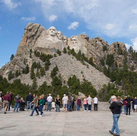 Visitors take in the massive sculpture carved into Mount Rushmore at the Mount Rushmore National Memorial Thursday, Sept. 21, 2023, in, Keystone, S.D.