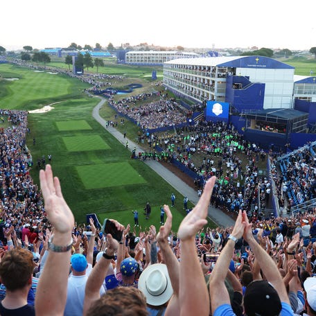 Luke Donald, captain of Team Europe, and Nicolas Colsaerts, vice captain, acknowledge the crowd on the first tee prior to the Friday morning foursomes matches of the 2023 Ryder Cup.