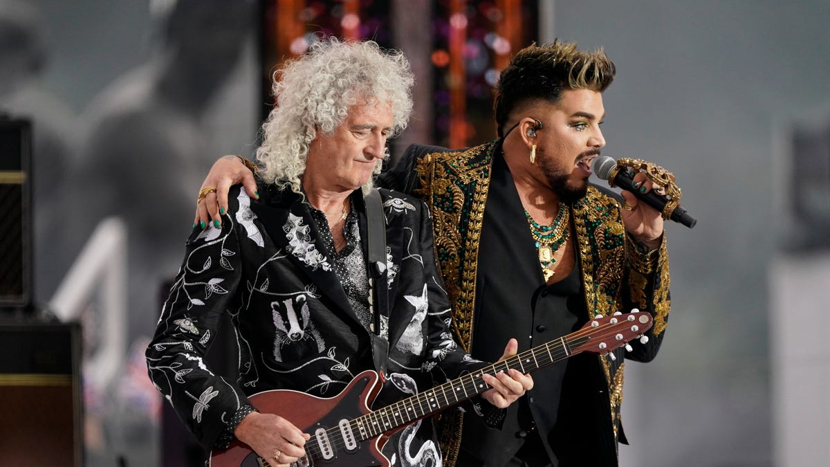 Brian May, left, and Adam Lambert from the band Queen perform in June 2022 at the Platinum Jubilee concert taking place in front of Buckingham Palace, London.
