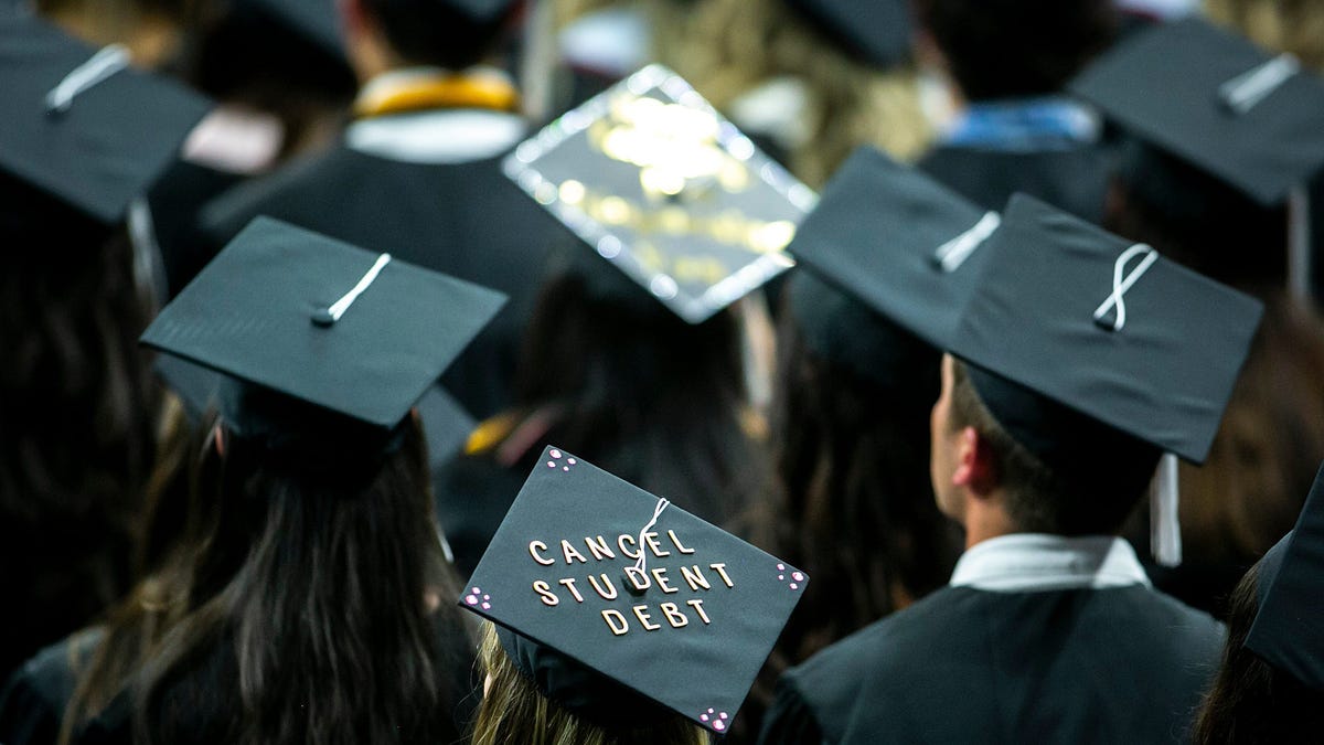 The cap of a University of Iowa graduate reads "Cancel student debt" during a commencement ceremony for the College of Liberal Arts and Sciences, Saturday, May 14, 2022, at Carver-Hawkeye Arena in Iowa City, Iowa.    220514 Ui Commencement 020 Jpg