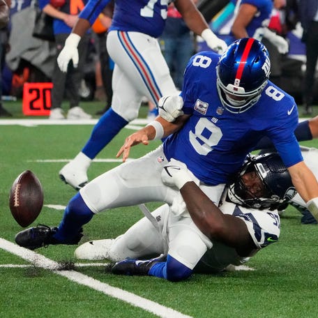 Seattle Seahawks defensive end Mario Edwards Jr. (97) strips the ball from New York Giants quarterback Daniel Jones (8). The Seahawks recovered.