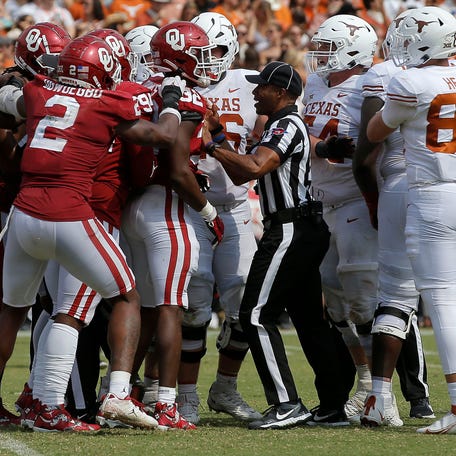 Oklahoma and Texas players get in an argument during their 2022 game at the Cotton Bowl in Dallas, Saturday, Oct. 8, 2022.