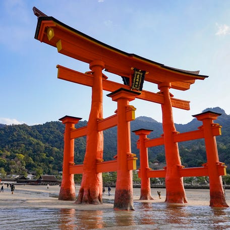 People approaching the Grand Torii Gate of the Itsukushima Shrine during low tide in Miyajima, Hiroshima, western Japan, on Thursday, Dec. 22, 2022.