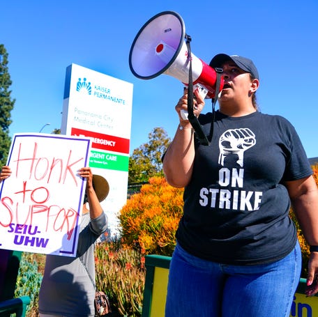 Jovanna Segura uses a bullhorn to lead chants with striking health care workers in front of Kaiser Permanente Medical Center in Panorama City, Calif. on Wednesday, Oct. 4, 2023. More than 75,000 Kaiser Permanente workers walked off the job Wednesday in what is being called the largest healthcare strike in U.S. history. Kaiser Permanente Unions and the healthcare provider in negotiations for a new contract, but workers still opted to hold a three-day   labor strike.