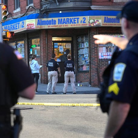 Law enforcement officials investigate the scene where multiple were shot, Wednesday, Oct. 4, 2023, in Holyoke, Mass. State police say at least three people, including a person riding a bus, were shot Wednesday in Holyoke following a fight on a downtown street. (AP Photo/Steven Senne)